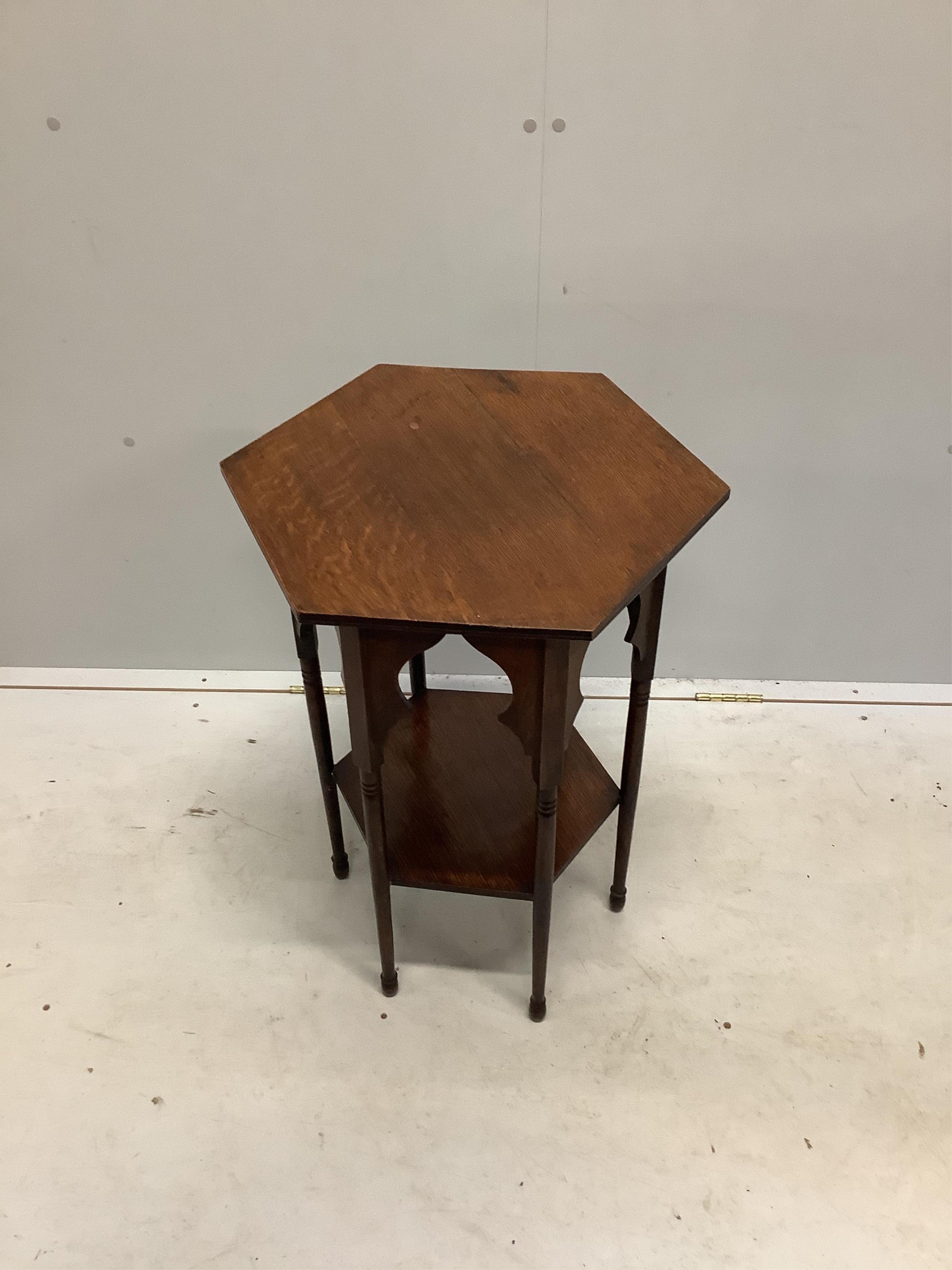 An Arts & Crafts Liberty style hexagonal oak occasional table, width 45cm, height 70cm. Condition - fair